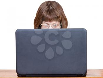 direct view of girl with spectacles reads from laptop screen