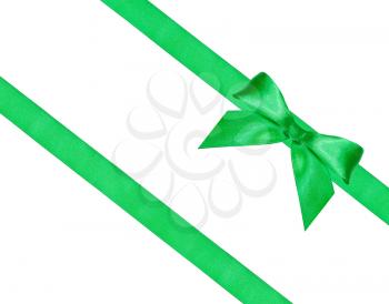 big green bow knot on two diagonal silk ribbons isolated on white background