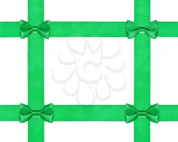 four little green bow knots on four satin ribbons isolated on white background