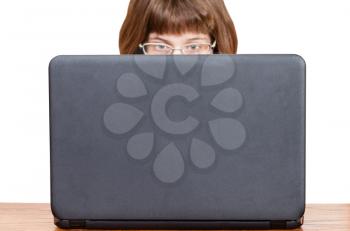 direct view of girl with glasses reads from laptop screen