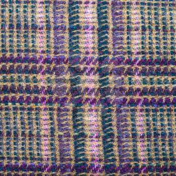 square background from checkered green, brown, violet, pink woolen fabric close up