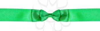 double bow knot on narrow green satin ribbon isolated on white background