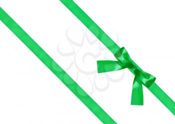 one green bow knot on two diagonal silk ribbons isolated on white background