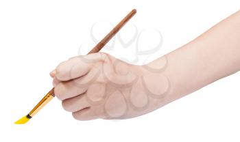 hand holds artistic paint brush with yellow painted tip isolated on white background