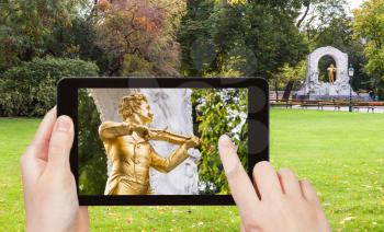 travel concept - tourist snapshot of monument of Johann Strauss son in Stadtpark (City Park) in Vienna on tablet pc