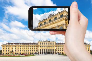 travel concept - tourist snapshot of Schloss Schonbrunn palace in Vienna on smartphone