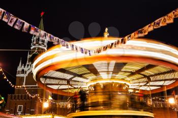 illuminated merry-go-round carousel on Red Square on Moscow Christmas Fair