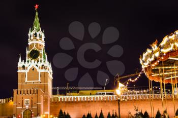 Spasskaya tower of Kremlin and Merry-go-round carousel on Red Square in Moscow in night