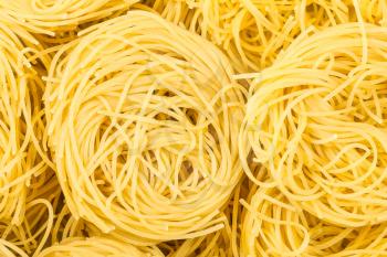 food background - nests of durum wheat semolina pasta fidelini