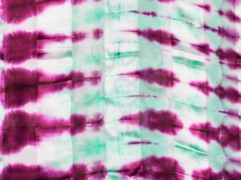textile background - abstract hand painted magenta and green spots on silk batik