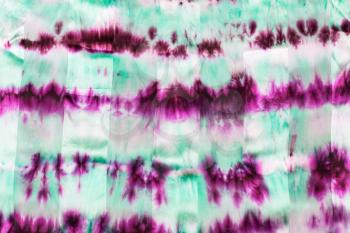 textile background - abstract hand painted magenta and green strips on silk batik