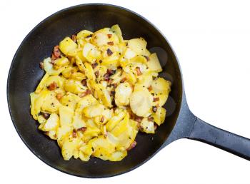 black frying pan with fried potatoes and bacon isolated on white background
