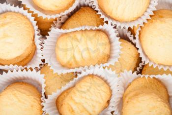 many sweet Shortbread cookie in white semi- parchment paper