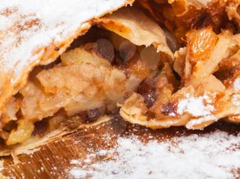 apple and raisins sweet stuffing in typical austrian dessert apple strudel close up