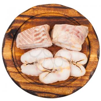 top view of pieces and slices of hot smoked Starry sturgeon and sturgeon fishes on wooden cutting board isolated on white background