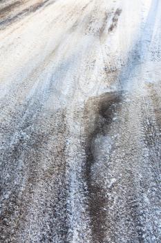 snow covered slippery asphalt road in winter in city