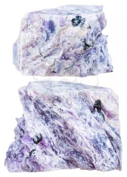 macro shooting of natural mineral stone - two pieces of charoite crystalline rock isolated on white background