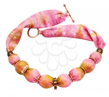 top view of textile necklace from pink and yellow painted silk balls and copper rings isolated on white background