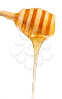 clear honey flowing down from wooden spoon close up isolated on white background