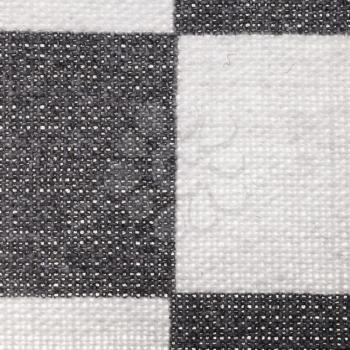 square textile background - checkered cotton fabric with Calico weave pattern of threads close up