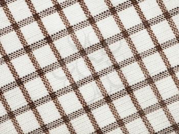 textile background - checkered cotton fabric with Calico weave pattern of threads close up