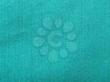textile background - silk green Taffeta cloth with weave pattern of threads close up