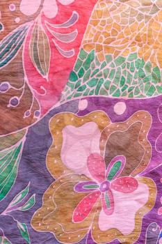 textile background - abstract hand painted floral pattern on pink and purple silk batik