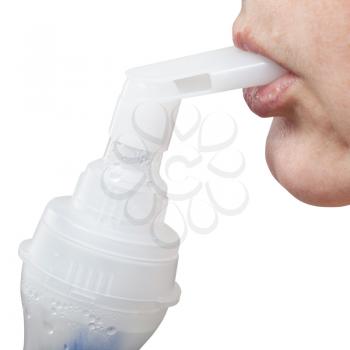 medical nebulization treatment - mouthpiece of modern jet nebulizer in lips of patient isolated on white background