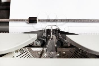typebar hits ink ribbon in mechanical typewriter close up