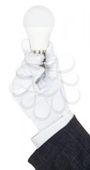 hand in business suit and textile glove holds compact LED lamp isolated on white background