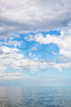 scenery of cumulus clouds over calm blue water Sea of Azov, Temryuk bay, Golubitskaya resort, Taman peninsula, Kuban, Russia