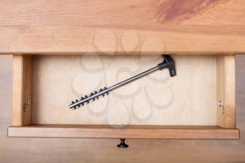 top view of one latchkey in open drawer of nightstand