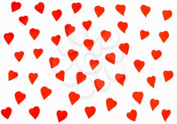 many red hearts cut out from paper on white background