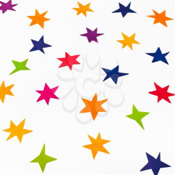 various stars carved from colored paper on white square background