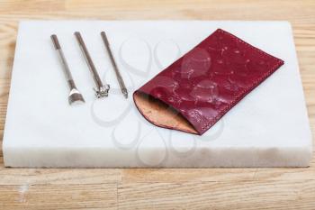 Leathercraft - new handmade leather pouch for eyeglass and embossing tools on marble plate