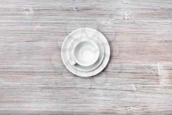 food concept - above view of one white cup with saucers on gray brown table