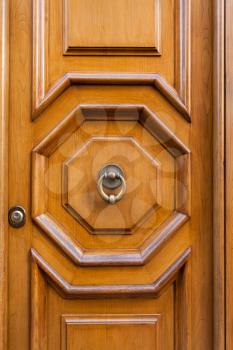 travel to Italy - old wooden door with brass door knocker in Rome city