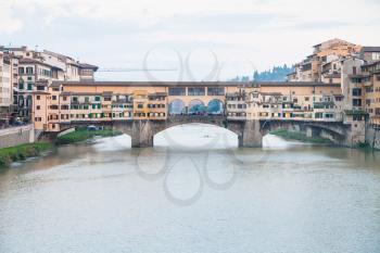 travel to Italy - view of Ponte Vecchio (Old Bridge) over Arno River in Florence city in evening twilight