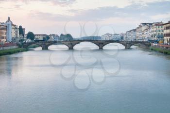 travel to Italy - view of ponte alla carraia over Arno River in Florence city in evening twilight