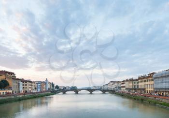 travel to Italy - blue sunset clouds over Arno River with Ponte alla Carraia bridge in Florence city in evening twilight