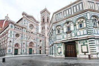 travel to Italy - Florence Baptistery (Battistero di San Giovanni, Baptistery of Saint John) and Duomo Cathedral Santa Maria del Fiore with Giotto's Campanile on Piazza San Giovanni in morning