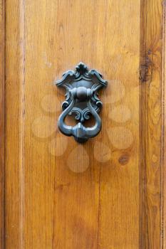 travel to Italy - bronze knocker on old wooden door in Florence city