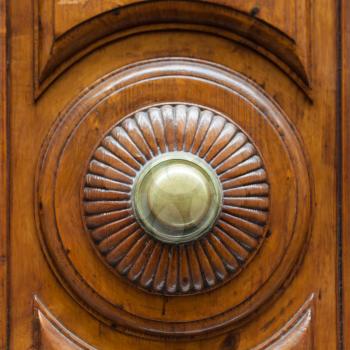travel to Italy - brass ring knob on wooden door in Florence city
