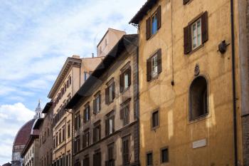 travel to Italy - old apartment buildings and dome of Cathedral on street in historic centre of Florence city