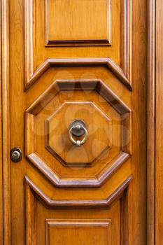 travel to Italy - wood door with brass ring door knocker in Rome city