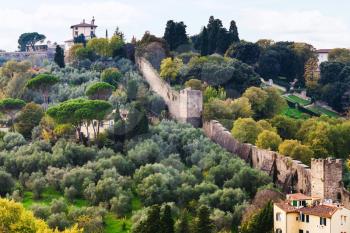 travel to Italy - view of green gardens and wall of Giardino Bardini from Piazzale Michelangelo in Florence city in autumn evening