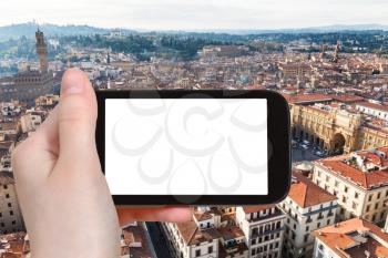 travel concept - tourist photographs Florence cityscape with piazza della repubblica on tablet with cut out screen with blank place for advertising in Italy