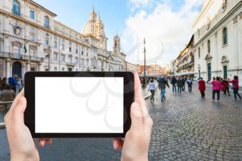 travel concept - tourist photographs Piazza Navona in Rome city on tablet with cut out screen with blank place for advertising in Italy