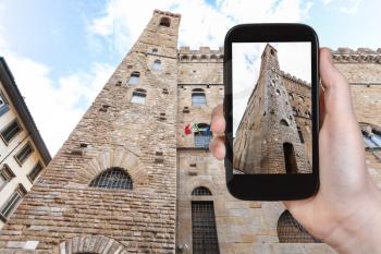 travel concept - tourist photographs Bargello palace in Florence city on smartphone in Italy