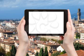 travel concept - tourist photographs Florence skyline on tablet with cut out screen with blank place for advertising in Italy